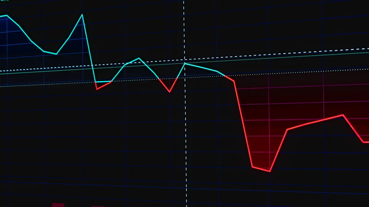 dark screen with a sharp downward trend line