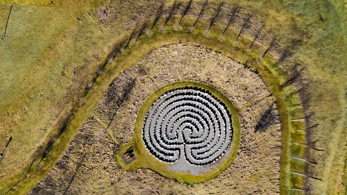 Top-down view of a circular maze in a field