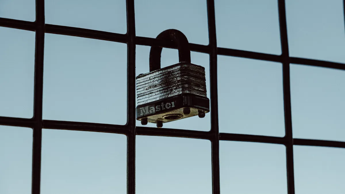 Padlock on a wire grid fence